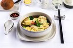 Chicken and prawn dumpling in savoury broth: Chicken and prawn dumplings served with Asian green vegetables and egg noodles in a savoury broth.